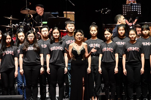 Pamela Tan-Nicholson with the youth choir from Singapore Raffles Music College